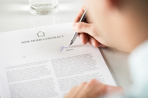 Businessman signing a contract in a formal setting